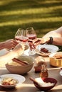 Friends toasting with wine over a spaghetti meal