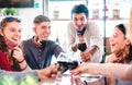 Friends toasting wine at restaurant wearing face masks - New normal lifestyle concept with happy people having fun together Royalty Free Stock Photo