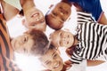 Friends together at recess. Low view of a group of schoolchildren looking down at you and huddling together.