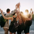 Friends tourists with backpacks rising hands