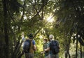 Friends trekking through forest together