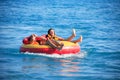 Friends Tubing On Sea Royalty Free Stock Photo