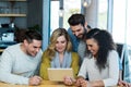 Friends using digital tablet in cafÃÂ© Royalty Free Stock Photo