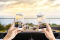 Friends using smartphones to take photos of empty glasses set in Royalty Free Stock Photo