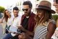 Friends on vacation in Ibiza looking at a guidebook, close up