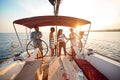 Friends on vacation travel on boat together and enjoy at summer day