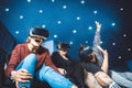 Friends in virtual glasses watching movies in the cinema with sp