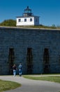 Friends Walking by Lighthouse Tower On Fort Royalty Free Stock Photo