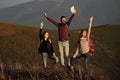 Friends walking on mountain. Tourists on nature. handsome bearded man in checkered shirt with pretty young cute girls or