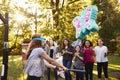 Friends watch pre-teen girl hitting a piÃ¯Â¿Â½ata on her birthday