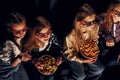 Friends watching movie together. Group of kids sitting in cinema Royalty Free Stock Photo