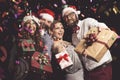 Friends holding Christmas gifts Royalty Free Stock Photo