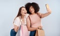 Friends, women with shopping bag and happy in selfie, retail customer and fashion isolated on studio background. Excited Royalty Free Stock Photo