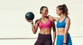 Friends, women and smile with medicine ball for exercise or workout in sportswear, fitness and healthy in New York Royalty Free Stock Photo