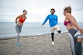 Friends worming up for a training on the beach Royalty Free Stock Photo