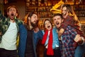 Friends, young people, friends, emotionally watching match at pub. Fans cheering up favourite sport team. Winning game Royalty Free Stock Photo