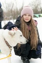 friendship adult person season animal snow outdoor woman husky pet winter young girl dog park Royalty Free Stock Photo