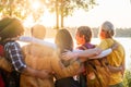 Friendship Aglow: Sunset Embrace by the Lake