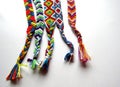 Friendship bracelets made of thread with braids on white background Royalty Free Stock Photo