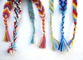 Friendship bracelets made of thread with braids on white background Royalty Free Stock Photo