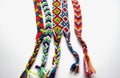 Friendship bracelets made of thread with braids on white background Royalty Free Stock Photo