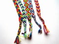 Friendship bracelets made of thread with braids on white background Royalty Free Stock Photo