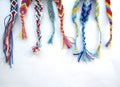 Friendship bracelets made of thread with braids on white background Royalty Free Stock Photo
