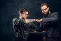 Friendship, brofist, cooperation. Two programmer`s colleagues fist bumping after completion of the general project in Royalty Free Stock Photo