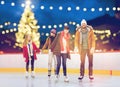 Happy friends on christmas skating rink Royalty Free Stock Photo