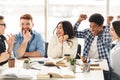 Friendship concept. Happy classmates talking in college library Royalty Free Stock Photo