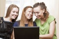 Friendship Concepts: Three Laughing Caucasian Girls Using Laptop Royalty Free Stock Photo