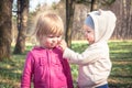 Friendship between cute baby girls playing together in park symbolizing children friendship