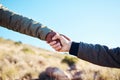 Friendship, help and men holding hands on a hike for support while climbing a rock on a mountain. Assistance, adventure Royalty Free Stock Photo