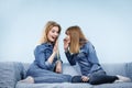 Two happy women friends wearing jeans outfit talking Royalty Free Stock Photo