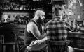 Friendship and leisure. Friday relaxation in bar. Friends relaxing in pub. Hipster brutal bearded man spend leisure with Royalty Free Stock Photo