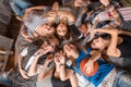 Friendship, leisure, summer and people concept - group of smiling friends lying on floor in circle indoors Royalty Free Stock Photo