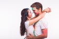 Friendship, love, festival of holi, people concept - young couple playing with colors at the festival of holi on white Royalty Free Stock Photo