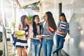 Friendship makes school more fun. a group of schoolgirls chatting in the hallway outside their classroom.