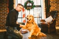 Friendship of man and dog. Pet golden retriever breed labrador shaggy dog. A man trains, teaches a dog to give a paw, to execute c Royalty Free Stock Photo