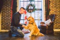 Friendship of man and dog. Pet golden retriever breed labrador shaggy dog. A man trains, teaches a dog to give a paw, to execute c Royalty Free Stock Photo