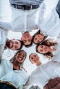 Friendship in office. Vertical image of happy diverse business people team gathering in circle Royalty Free Stock Photo