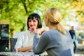 Friendship or rivalry. Girls friends drink coffee talk. Conversation of two women cafe terrace. Friendship friendly Royalty Free Stock Photo