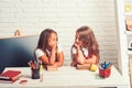 Friendship of small sisters in classroom at knowledge day. Little girls eat apple at lunch break. bored school kids at Royalty Free Stock Photo
