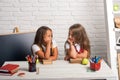 Friendship of small sisters in classroom at knowledge day. Little girls eat apple at lunch break. bored school kids at Royalty Free Stock Photo