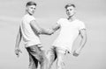 Friendship and support. Men muscular twins brothers in white shirts sky background. Brotherhood concept. Benefits and