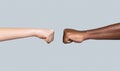 Friendship, team, good work. Multicultural friends giving fist bump to each other. Black African American race male and