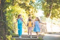 Three happy school girls running and holding hands in nature Royalty Free Stock Photo