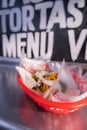 Fries and onions on a plastic basket with words as background