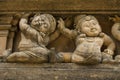 Frieze of dwarves on Buddhist building facade