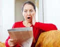 Fright woman with newspaper Royalty Free Stock Photo